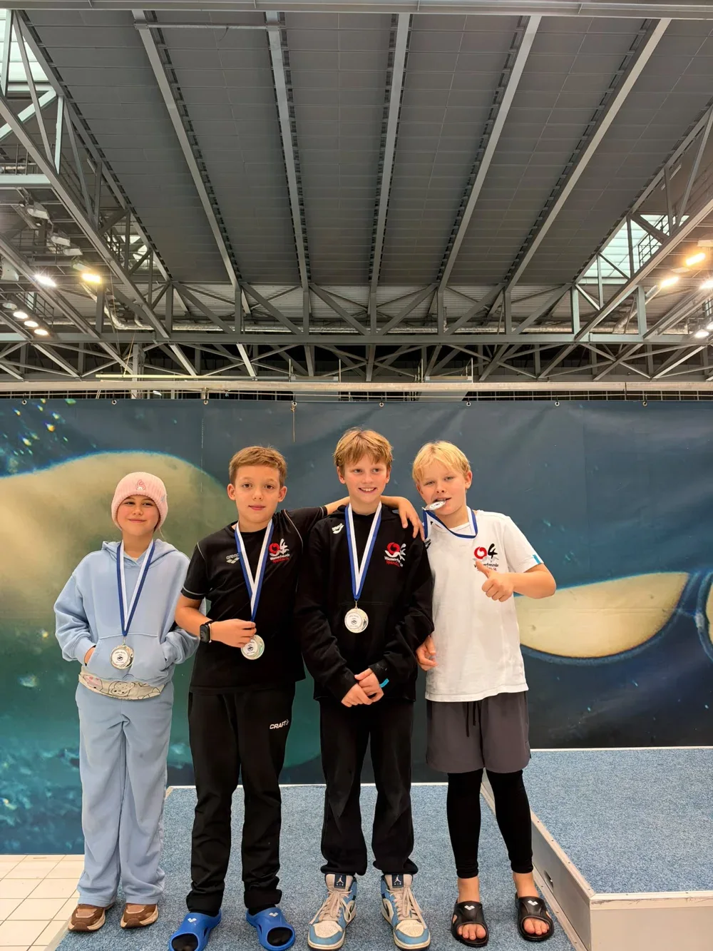 Vier junge Spandauer Schwimmerinnen und Schwimmer mit Medaillen